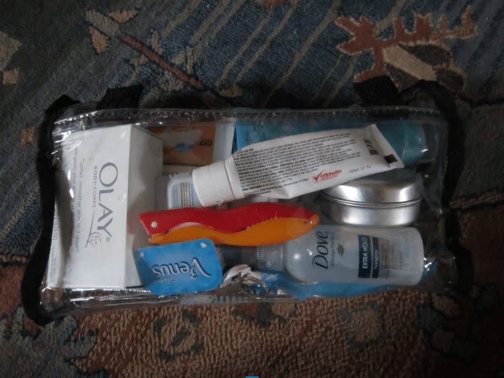 A toiletry bag filled with soap, toothbrush, razors, and more.
